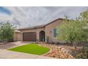 Charming single-story home with desert landscaping, a paver driveway, and an attached two-car garage at 13189 W Caleb Rd, Peoria, AZ 85383