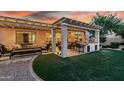 Outdoor living space featuring covered patio, built-in barbeque, and artificial grass at 18355 W Piedmont Rd, Goodyear, AZ 85338