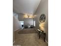 Spacious entryway with high ceilings, tiled floors, and tasteful decor, creates a welcoming ambiance at 23236 W Yavapai St, Buckeye, AZ 85326