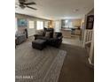 Comfortable living room showcasing an open layout with views into the kitchen and breakfast nook at 23236 W Yavapai St, Buckeye, AZ 85326