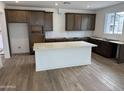 Spacious kitchen area featuring an island, wood floors, and recessed lighting at 2455 W Rowel Rd, Phoenix, AZ 85085