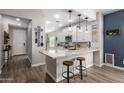 Bright, spacious kitchen with white cabinets, granite countertops, stainless steel appliances, and a breakfast bar at 3302 E Lantana Pl, Chandler, AZ 85286