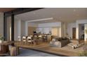 Open-concept living space featuring modern kitchen, dining area, comfortable seating, and seamless access to an outdoor space at 4849 N Camelback Ridge Rd # A309, Scottsdale, AZ 85251