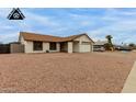 Well-maintained single-story home with a desert landscape and two-car garage at 8007 W Corrine Dr, Peoria, AZ 85381