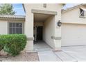 A cozy front porch with an inviting entryway, stylish lanterns, and neatly trimmed shrubs, showcasing curb appeal at 10605 W Windsor Ave, Avondale, AZ 85392