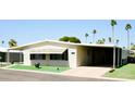 Beautiful home with a covered parking, offering shade and convenience, surrounded by palm trees at 120 N Val Vista Dr # 230, Mesa, AZ 85213