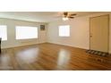 Inviting living room featuring hardwood floors, large windows providing ample natural light, and a ceiling fan at 120 N Val Vista Dr # 230, Mesa, AZ 85213