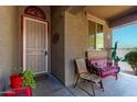 Cozy front porch with a decorative bench and greenery that creates a welcoming entryway at 12033 W Davis Ln, Avondale, AZ 85323