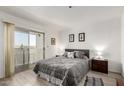 Bright main bedroom with balcony access, gray color scheme and soft textures at 12123 W Bell Rd # 339, Surprise, AZ 85378