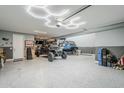 Spacious three-car garage with epoxy flooring and custom lighting at 13941 W Tierra Grande --, Surprise, AZ 85387