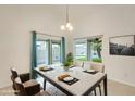 Cozy dining area featuring a modern table setting, ample natural light, and view of the backyard at 17514 N Rainbow Cir, Surprise, AZ 85374