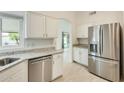 Bright kitchen with stainless steel dishwasher and refrigerator at 17514 N Rainbow Cir, Surprise, AZ 85374