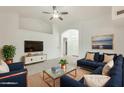 Bright living room featuring a comfortable sectional sofa, modern TV console, and stylish decor at 17514 N Rainbow Cir, Surprise, AZ 85374