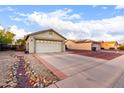 Single-story home showcasing a driveway and a two-car garage in a residential area at 1758 E Birch St, Casa Grande, AZ 85122