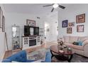 Cozy living room with wood floors, ceiling fan and decorative shelving at 1758 E Birch St, Casa Grande, AZ 85122