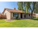 Single story home featuring lush green lawn, mature landscaping and desert flora, and a two car garage at 19258 N 20Th Dr, Phoenix, AZ 85027