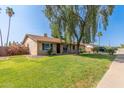 Single story home featuring lush green lawn, mature landscaping and desert flora, and a two car garage at 19258 N 20Th Dr, Phoenix, AZ 85027