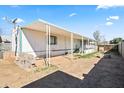 The home's backyard features a covered awning and partial landscaping at 1939 E Libby St, Phoenix, AZ 85022
