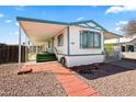The front of the home features a covered awning, tiled walkway, and green front porch at 1939 E Libby St, Phoenix, AZ 85022