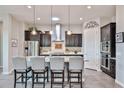 Modern kitchen features stainless steel appliances, granite countertops, and a stylish island at 20631 W Minnezona Ave, Buckeye, AZ 85396