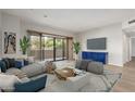 Bright living room boasts a sliding glass door to a balcony and contemporary furnishings for comfortable lounging at 20660 N 40Th St # 1112, Phoenix, AZ 85050
