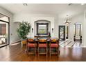 Spacious dining area featuring hardwood floors, custom cabinetry, and comfortable seating at 21235 N 80Th Way, Scottsdale, AZ 85255
