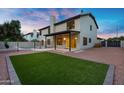 Large backyard featuring a manicured lawn, covered patio, and fenced pool area at 2522 N Robin Ln, Mesa, AZ 85213