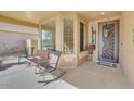 Cozy front porch with seating area, decorative door, and neutral colors at 2857 N Mystic Ct, Casa Grande, AZ 85122