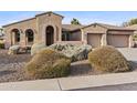 Charming single-story home featuring a spacious three car garage and manicured desert landscaping at 2894 E Nolan Pl, Chandler, AZ 85249