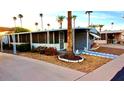 Inviting single-story home with a covered patio, desert landscaping, and a screened patio at 303 S Recker Rd # 74, Mesa, AZ 85206