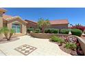 View of the front courtyard with desert landscaping and a tiled patio at 3147 N Couples Dr, Goodyear, AZ 85395