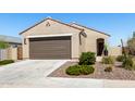 Charming one-story home with a two-car garage, complemented by desert landscaping and a tile roof at 3670 E Sandoval Dr, San Tan Valley, AZ 85140