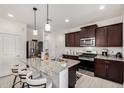 Modern kitchen featuring stainless steel appliances, granite countertops, and a breakfast bar with seating at 3670 E Sandoval Dr, San Tan Valley, AZ 85140