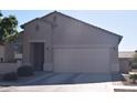 Traditional home with a two-car garage and desert landscaping at 429 N San Ricardo N Trl, Casa Grande, AZ 85194