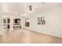 Open living room with tile floors with open access to the kitchen and backyard at 43142 N Outer Bank Dr, Anthem, AZ 85086