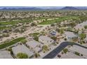 Aerial shot of homes in a desert community bordering a lush golf course at 4864 E Eden Dr, Cave Creek, AZ 85331