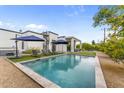 Beautiful pool and backyard featuring a modern home with a spiral staircase and outdoor lounge area at 5036 N Scottsdale Rd, Paradise Valley, AZ 85253