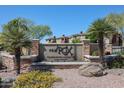 Beautifully landscaped community sign surrounded by desert plants and a view of residential buildings beyond at 5401 E Van Buren St # 3113, Phoenix, AZ 85008