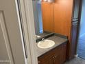 Bathroom featuring a vanity with dark countertops, wood cabinets, and a large mirror at 7008 E Gold Dust Ave # 234, Paradise Valley, AZ 85253