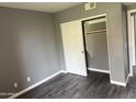 Bedroom with neutral colored walls and flooring, white trim, and a closet with sliding doors at 7008 E Gold Dust Ave # 234, Paradise Valley, AZ 85253