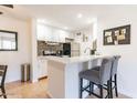 Charming kitchen with white cabinets, stainless steel appliances, and a breakfast bar with comfortable seating at 8055 E Thomas Rd # G101, Scottsdale, AZ 85251
