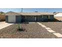 Charming single-story home with well-maintained gravel yard, walkway and gray exterior paint at 8115 E Cypress St, Scottsdale, AZ 85257