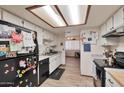 Bright kitchen with white cabinets, modern appliances, and view of the dining and living areas at 876 W El Monte Pl # 3, Chandler, AZ 85225