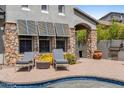 Relaxing backyard retreat featuring a pool with chairs, lush landscaping, and a barbecue area at 9285 E Canyon Vw, Scottsdale, AZ 85255