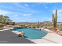 Backyard pool oasis with a stunning desert landscape and relaxing water feature at 9620 E Roadrunner Dr, Scottsdale, AZ 85262