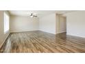 Spacious living room featuring wood-look tile flooring and a modern ceiling fan at 1055 W Dragoon Ave, Mesa, AZ 85210