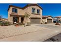 Charming two-story home with a two-car garage, covered entry, and desert landscaping at 1472 E Avenida Kino --, Casa Grande, AZ 85122