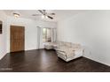 Inviting living room with hardwood floors, comfortable seating, a ceiling fan, and natural light at 1472 E Avenida Kino --, Casa Grande, AZ 85122
