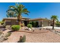 Attractive home with desert landscaping including gravel, rocks, and mature, lush shrubbery at 15136 W Cactus Ridge Way, Surprise, AZ 85374