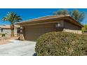 Two car garage with desert landscaping and concrete driveway on a clear day at 15136 W Cactus Ridge Way, Surprise, AZ 85374